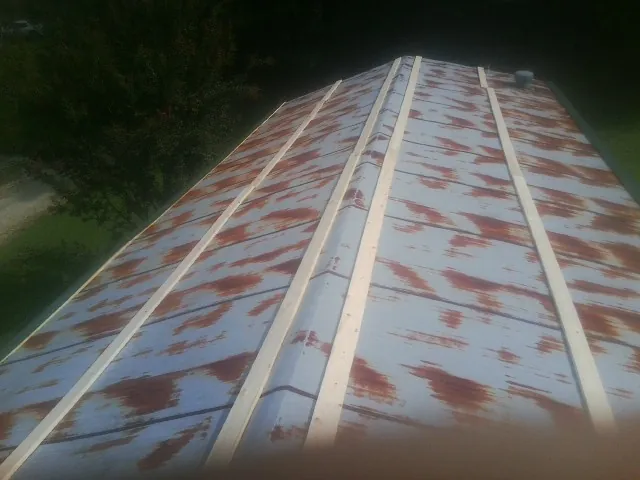 Rusted metal roof panels with new wood purlins before replacement — Storm Damage Roof Repair in Osyka by Roofing Brothers